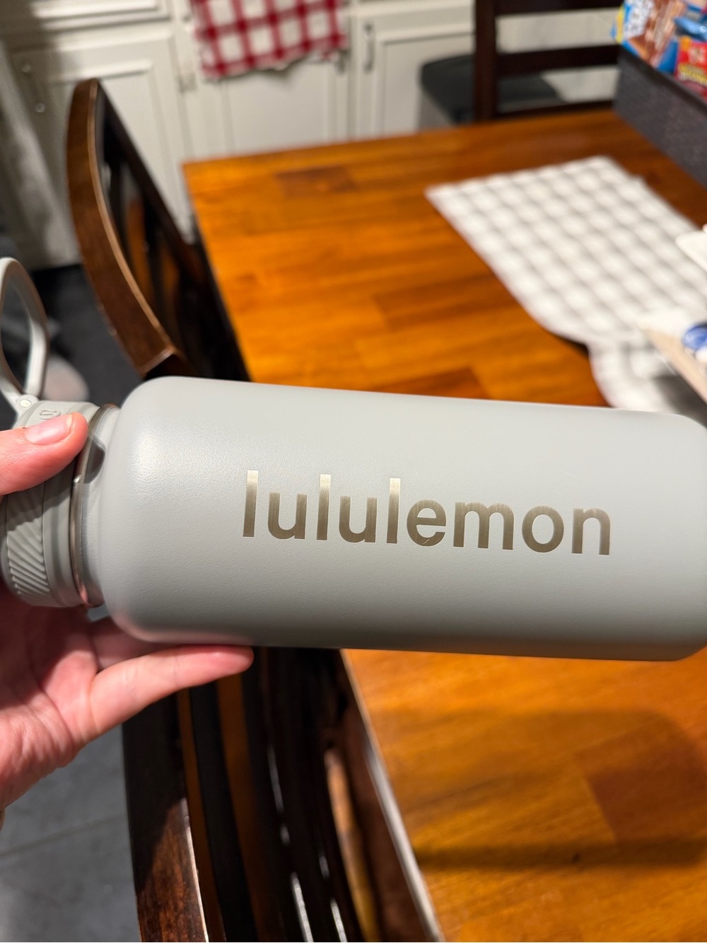 lululemon light gray water bottle with gold logo